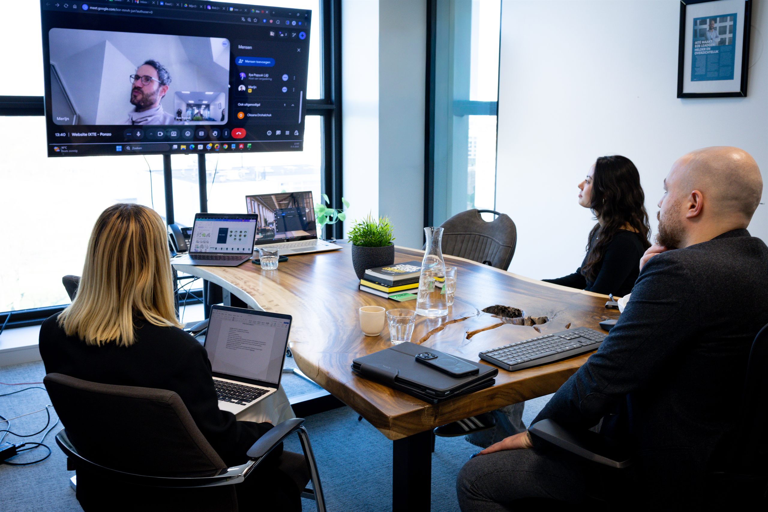 Campagne-overleg bij IXTE met videoverbinding op groot scherm